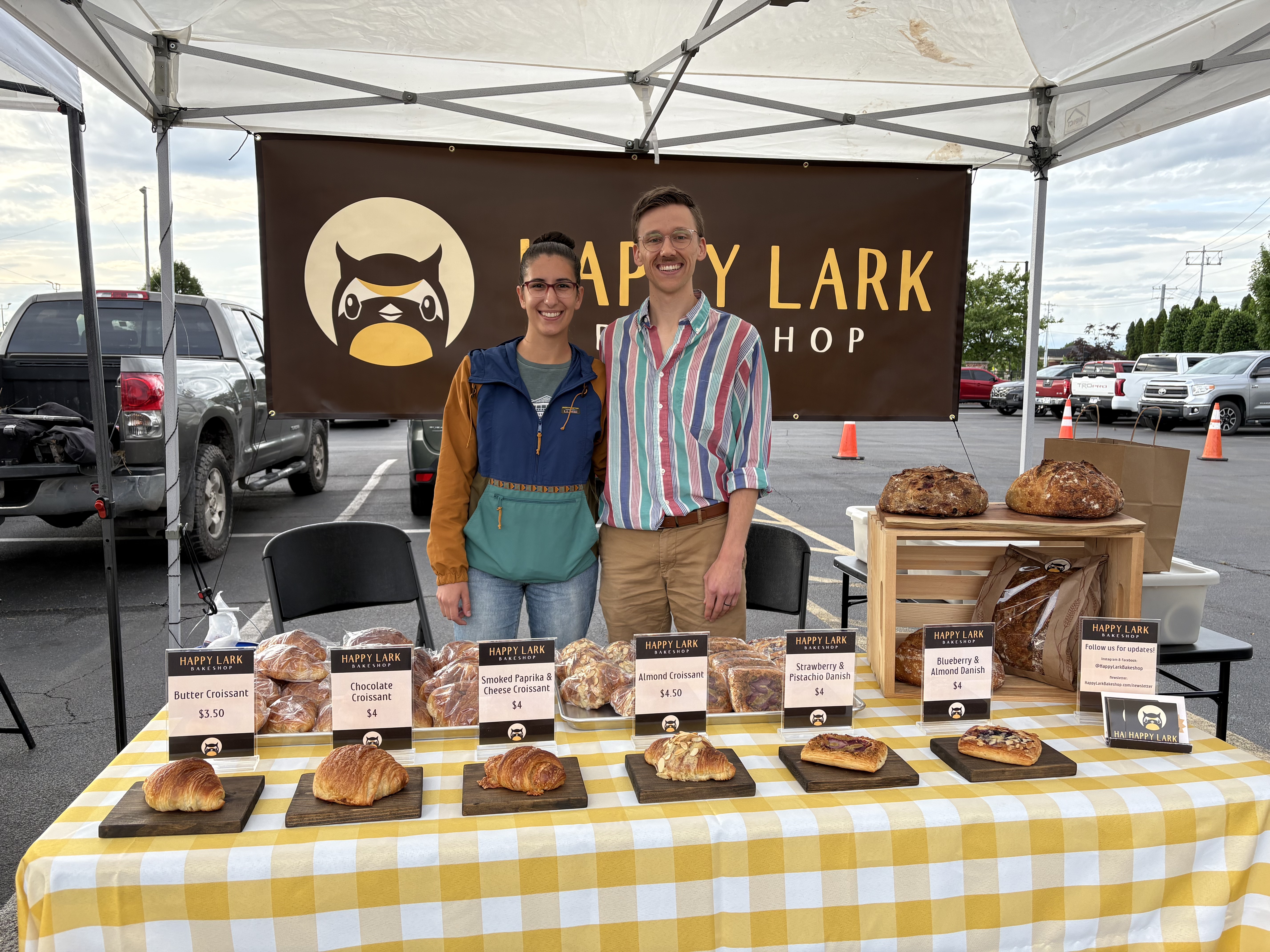 Walker and Olivia selling croissants at the farmers market